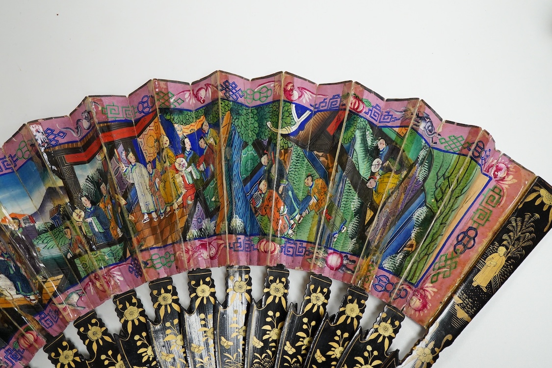 Four 19th century Chinese gilt-decorated black lacquer fans with figure painted leaves, two cased, largest 41cm